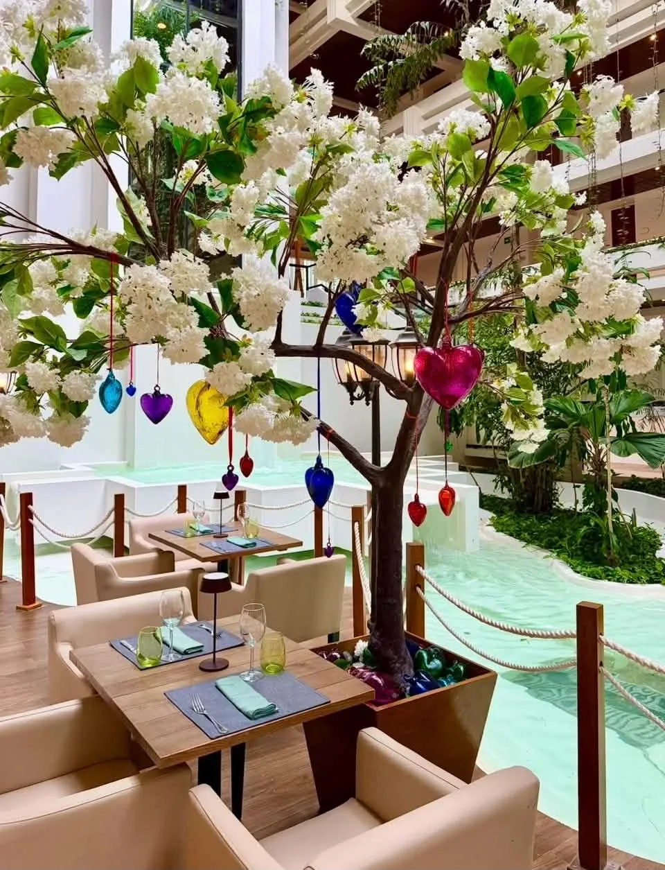 Indoor restaurant seating beside the water feature at Paradisus Cancún